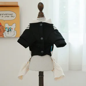 Detail of pet jumper featuring large black buttons and beige striped ribbed cuffs