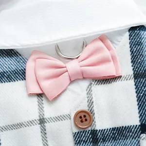 Close-up of pink satin bowtie and blue plaid vest with D-ring for dog formal suit