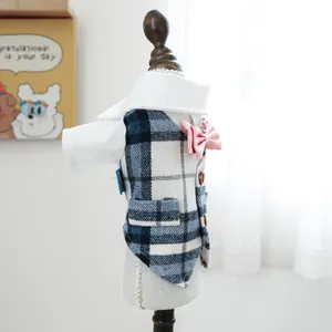 Detailed view of blue plaid pet tuxedo with white shirt, pink bowtie and metal D-ring
