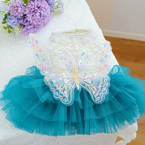 Macro detail of pet dress with 3D butterfly embroidery and layered tulle skirt