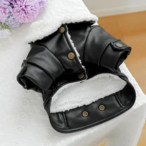 Close-up of black pet leather jacket with white faux shearling lining and metal snaps