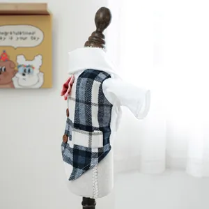 Detail of blue plaid pet tuxedo vest with pink bowknot and buttons for small dogs