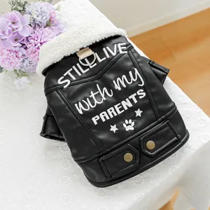 Detail of dog leather jacket with white faux fur collar and embroidered text on back