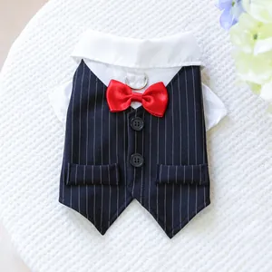 Detail of dog tuxedo vest featuring red bowtie and metal D-ring for leash attachment