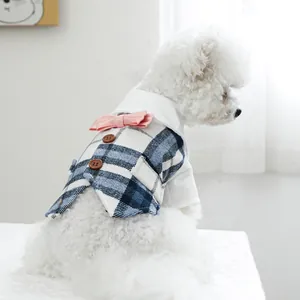 Detail of blue plaid pet tuxedo vest with pink bowknot and white collar for small dogs