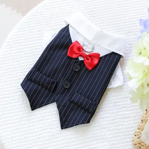 Close-up of a pet tuxedo vest with striped pattern, red bowtie and metal D-ring attachment