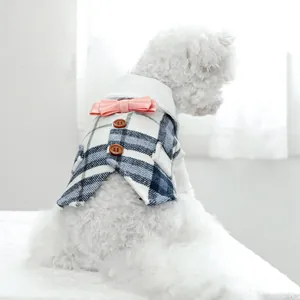 Detailed back view of a pet tuxedo featuring a blue plaid pattern and pink bow tie