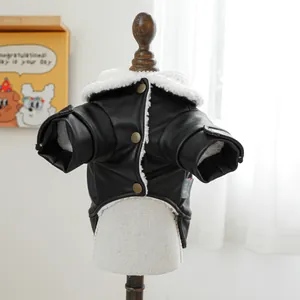 Close-up of black leather dog coat with white fleece lining and vintage copper buttons