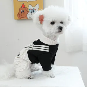 Detail of dog overall jumpsuit with black sporty top and white corduroy pants