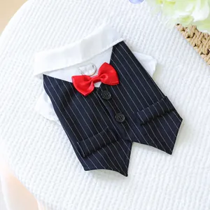 Close-up of pet tuxedo vest featuring navy stripes, red bowtie, and silver D-ring leash attachment