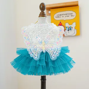 Detailed view of luxury pet dress featuring embroidered butterfly wings and teal mesh tutu