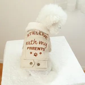 Detail of warm dog coat featuring leather fabric, sherpa collar, and back embroidery