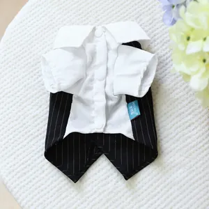 Macro shot of pet formal tuxedo suit showing white shirt buttons and striped vest texture