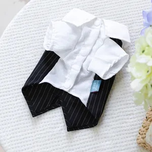 Detail of pet tuxedo suit featuring white buttoned shirt and black striped vest texture