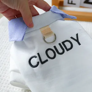 Detail of dog shirt featuring blue striped collar, D-ring attachment and Cloudy embroidery