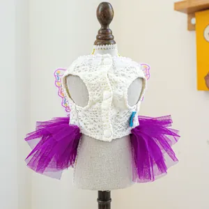 Detailed view of pet dress with white lace bodice and purple mesh fairy wings