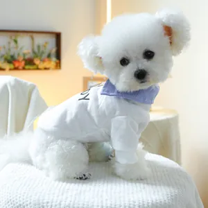 Detail of white cotton pet sweatshirt with striped collar and BOY print on a small dog