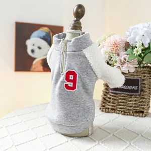 Detail of gray pet hoodie with white fleece sleeves and embroidered number nine