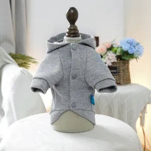 Detail of grey waffle fabric pet hoodie with three buttons on a wooden mannequin