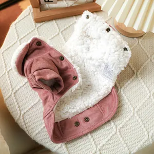Detail of warm pink faux suede pet coat with thick white fleece lining and metal buttons