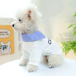 Detail of white pet sweater with navy striped collar and embroidery on a poodle