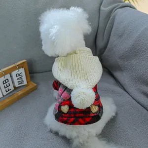 Detail of red plaid dog hoodie with cream knit hood and plush pompom for winter