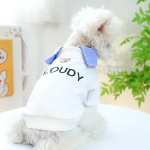 Detail of pet sweatshirt with blue striped collar and silver D-ring on white cotton fabric