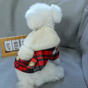 Close-up of red plaid dog coat with knit collar, fuzzy pom-pom and heart detail