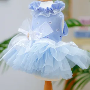 Detail of light blue pet dress with daisy print lace edges and a large organza bow