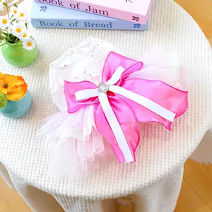 Detail of pet princess dress featuring a pink satin bow, sequins, and fluffy tulle skirt