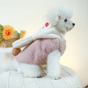 Close-up of pink lamb wool pet hoodie with bunny ears and soft plush texture