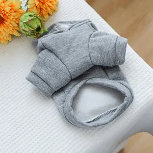 Detail of gray pet hoodie showing soft marled knit fabric and ribbed cuffs on white textile
