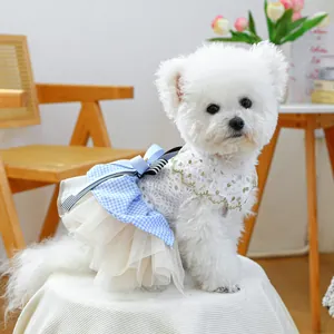 Detail of pet dress with blue lace bow, tulle skirt and gold trim for small dogs