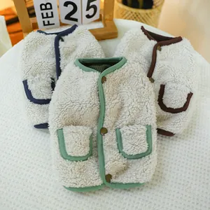 Detailed view of plush warm pet vests in green, blue, and brown with decorative pockets