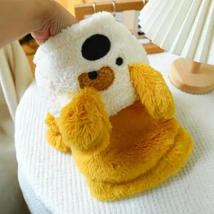Close-up of ginger yellow plush dog coat featuring cute cartoon face embroidery and soft texture