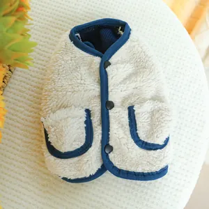Close-up of fluffy sherpa fleece pet vest with blue trim and buttons detail