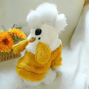 Detailed plush texture of a yellow and white fleece dog coat with cartoon ear design