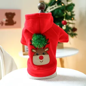 Macro shot of red pet hoodie with plush elk embroidery and festive green pom-pom detail