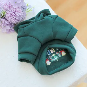 Detail of green pet hoodie showing warm fleece lining and festive Christmas embroidery