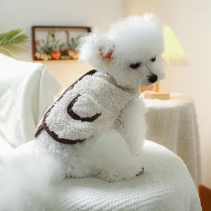 Detail of warm lamb wool pet vest in cream with brown trim for small dogs and cats
