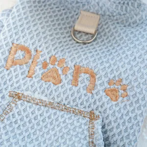 Macro detail of light blue waffle fabric pet vest with D-ring and Plan embroidery