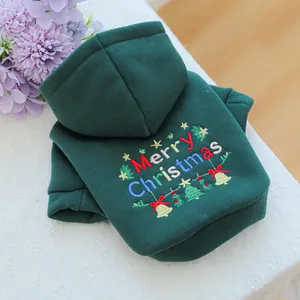 Detail of green pet hoodie with Merry Christmas embroidery and festive tree patterns