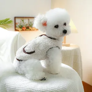 Detail of warm white fleece pet vest with brown trim on a small toy poodle