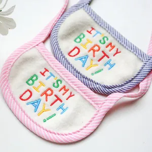 Detailed view of birthday pet bibs with colorful embroidery and soft striped edges