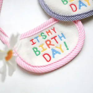 Detail of soft pet birthday bib with It's My Birthday embroidery and striped edges