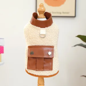 Off-white sherpa dog vest with brown leather accents and a metal D-ring attachment
