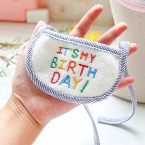 Detail of pet birthday bandana with It's My Birthday embroidery and blue stripe trim