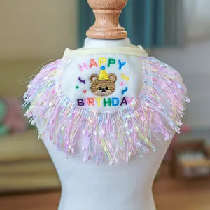 Macro shot of pet birthday bandana with Happy Birthday embroidery and colorful tassels