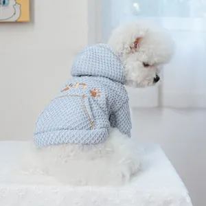 Detail of light blue waffle knit pet hoodie with cat paw embroidery on back pocket