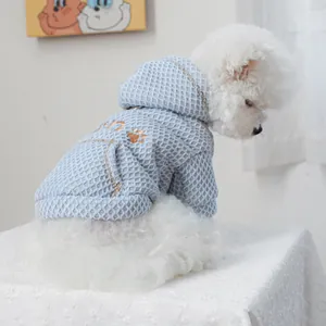 Detail of light blue waffle knit pet hoodie with gold sequin paw embroidery and pocket